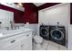 Well-lit bathroom with modern sink, vanity, and in-unit washer and dryer for added convenience at 405 8Th N Ave, Tierra Verde, FL 33715