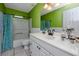 Cozy bathroom with lime green walls, tile floors, white cabinets, and tub and shower combo at 405 8Th N Ave, Tierra Verde, FL 33715