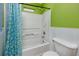 Bathroom featuring green walls, and a bathtub and shower combination with a white shower curtain at 405 8Th N Ave, Tierra Verde, FL 33715
