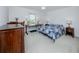 Bright bedroom featuring a bed with a blue quilt, neutral carpet, and built in desk area at 405 8Th N Ave, Tierra Verde, FL 33715