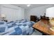 Bedroom features a bed with a blue quilt, white walls, closet with white doors, and built in desk at 405 8Th N Ave, Tierra Verde, FL 33715