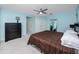 Spacious bedroom with blue walls, a ceiling fan, and ample closet space for all your storage needs at 405 8Th N Ave, Tierra Verde, FL 33715