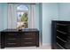 Well-lit bedroom with neutral carpet, modern window, and large dresser, creates a peaceful retreat at 405 8Th N Ave, Tierra Verde, FL 33715