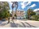 Two-story, single Gathering home with a well-manicured lawn, 2-car garage, and tropical landscaping at 405 8Th N Ave, Tierra Verde, FL 33715