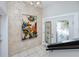 Entry foyer featuring decorative artwork, tiled flooring, and a glass panel door at 405 8Th N Ave, Tierra Verde, FL 33715