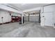 Spacious garage with concrete floors, white walls and ceilings, shelving and two garage doors at 405 8Th N Ave, Tierra Verde, FL 33715