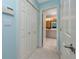 Hallway with a closet leading to a well-lit bathroom with a vanity, toilet, and shower at 405 8Th N Ave, Tierra Verde, FL 33715