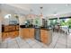 Open kitchen with granite countertops, stainless steel appliances and adjacent breakfast nook at 405 8Th N Ave, Tierra Verde, FL 33715