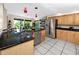 Spacious eat-in kitchen with stainless steel appliances, granite countertops, and a center island at 405 8Th N Ave, Tierra Verde, FL 33715