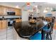 Open-concept kitchen with breakfast bar island, stainless appliances, and granite countertops at 405 8Th N Ave, Tierra Verde, FL 33715
