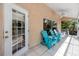 Covered lanai featuring stylish outdoor furniture, a ceiling fan, and lots of light at 405 8Th N Ave, Tierra Verde, FL 33715