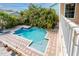 Outdoor pool area with brick pavers and surrounded by lush tropical landscaping and manicured palms at 405 8Th N Ave, Tierra Verde, FL 33715