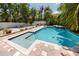 Inviting in-ground pool with brick pavers, manicured landscaping, and a tanning ledge at 405 8Th N Ave, Tierra Verde, FL 33715