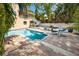 Backyard in ground pool with brick pavers, lounge chairs, lush tropical landscaping, and stairs at 405 8Th N Ave, Tierra Verde, FL 33715