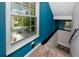 Staircase featuring carpeted steps, a teal wall, and a window offering natural light at 405 8Th N Ave, Tierra Verde, FL 33715