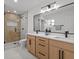 This bathroom features dual sinks, modern fixtures, and a glass door shower at 4210 Palm Dr, Punta Gorda, FL 33950