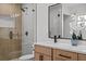 This modern bathroom features dual sinks, a marble countertop, and a glass door shower at 4210 Palm Dr, Punta Gorda, FL 33950