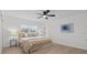 Bright and inviting bedroom with neutral tones and hardwood floors with a ceiling fan at 4210 Palm Dr, Punta Gorda, FL 33950