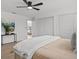 This bright bedroom features a ceiling fan, light wood floors, and double door closet at 4210 Palm Dr, Punta Gorda, FL 33950