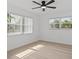 This bedroom features light wood floors, large windows, and ample natural light at 4210 Palm Dr, Punta Gorda, FL 33950