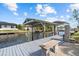 A waterfront view of the private dock featuring a boat lift, bench, and access to the serene canal at 4210 Palm Dr, Punta Gorda, FL 33950
