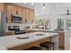 Bright kitchen features quartz countertop island, stainless steel appliances, modern cabinets, and eat in kitchen area at 4210 Palm Dr, Punta Gorda, FL 33950
