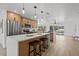 Modern kitchen featuring stainless steel appliances, an island with seating, and natural wood cabinets at 4210 Palm Dr, Punta Gorda, FL 33950