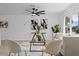 Bright and airy living room with a ceiling fan, neutral decor, hardwood floors, and large windows at 4210 Palm Dr, Punta Gorda, FL 33950