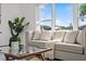 Comfortable living room featuring a cozy couch, large window, and views of the outdoors at 4210 Palm Dr, Punta Gorda, FL 33950