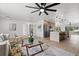 Bright living room featuring hardwood floors, modern furnishings, and an open concept design leading to the kitchen at 4210 Palm Dr, Punta Gorda, FL 33950
