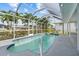 Enjoy the screened-in pool area, perfect for outdoor relaxation and overlooking the lush greenery and tall palm trees at 4210 Palm Dr, Punta Gorda, FL 33950
