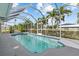 This enclosed pool features palm trees and blue trim at 4210 Palm Dr, Punta Gorda, FL 33950