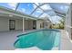 The screened in pool features a unique design and a spacious concrete deck for comfortable lounging and entertaining at 4210 Palm Dr, Punta Gorda, FL 33950