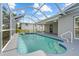 This enclosed pool features a staircase entry and blue trim at 4210 Palm Dr, Punta Gorda, FL 33950