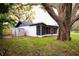 View of the home's screened porch, storage shed, and backyard at 4260 Saint Lawrence Dr, New Port Richey, FL 34655