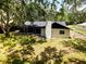 Lush backyard with mature trees offers privacy and shade for outdoor enjoyment and relaxation at 4260 Saint Lawrence Dr, New Port Richey, FL 34655