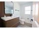Bathroom featuring modern vanity, stylish mirror, and neutral color scheme at 4260 Saint Lawrence Dr, New Port Richey, FL 34655
