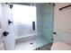 Marble tiled walk-in shower, glass door, and modern fixtures in renovated bathroom at 4260 Saint Lawrence Dr, New Port Richey, FL 34655