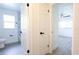 Bright bathroom showcasing marble shower, white door, and tile flooring at 4260 Saint Lawrence Dr, New Port Richey, FL 34655