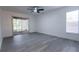 Spacious bedroom featuring sliding glass doors, modern ceiling fan, and tile flooring at 4260 Saint Lawrence Dr, New Port Richey, FL 34655