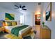 Stylishly staged bedroom with bed, dresser, ceiling fan, and decor at 4260 Saint Lawrence Dr, New Port Richey, FL 34655
