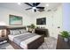 Staged bedroom features a bed, TV, ceiling fan and closet at 4260 Saint Lawrence Dr, New Port Richey, FL 34655