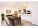 Dining room with adjacent modern kitchen, stainless fridge, and a pass-through window for easy serving at 4260 Saint Lawrence Dr, New Port Richey, FL 34655