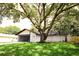 Charming home with a well-maintained lawn and a large, mature tree providing ample shade at 4260 Saint Lawrence Dr, New Port Richey, FL 34655