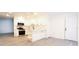 Newly renovated kitchen with modern appliances, white cabinets, and a functional layout at 4260 Saint Lawrence Dr, New Port Richey, FL 34655