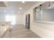 Bright kitchen area with stainless steel fridge and sliding glass door leading to the outdoors at 4260 Saint Lawrence Dr, New Port Richey, FL 34655