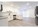 Bright, updated kitchen with stainless steel appliances, white cabinets, and center island for added workspace at 4260 Saint Lawrence Dr, New Port Richey, FL 34655