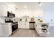 Modern kitchen featuring white cabinets, stainless steel appliances, and light countertops at 4260 Saint Lawrence Dr, New Port Richey, FL 34655