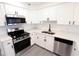 Well-lit kitchen with stainless steel appliances and white cabinetry provides a clean and modern aesthetic at 4260 Saint Lawrence Dr, New Port Richey, FL 34655