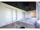 Covered patio with sliding glass doors, ceiling fans, and rock landscaping at 4260 Saint Lawrence Dr, New Port Richey, FL 34655